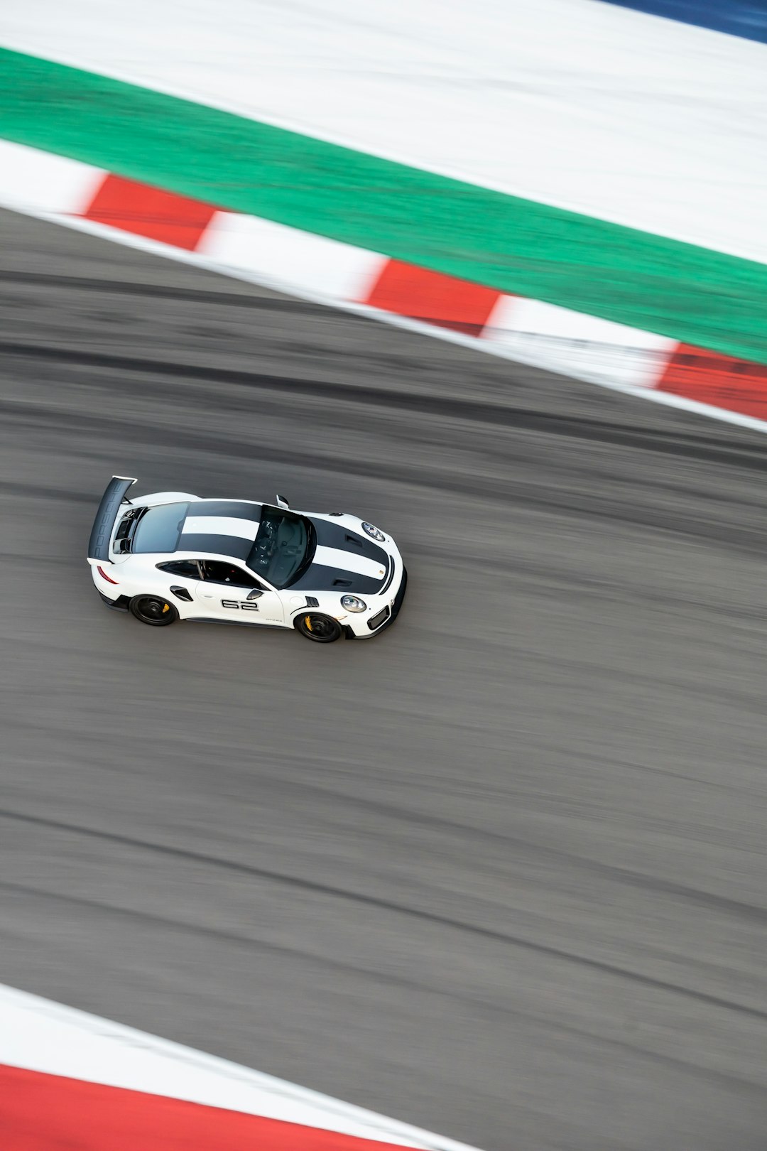 white and black porsche 911 on track