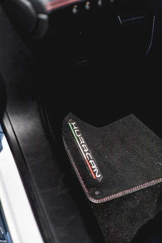 the interior of a car with a black floor mat