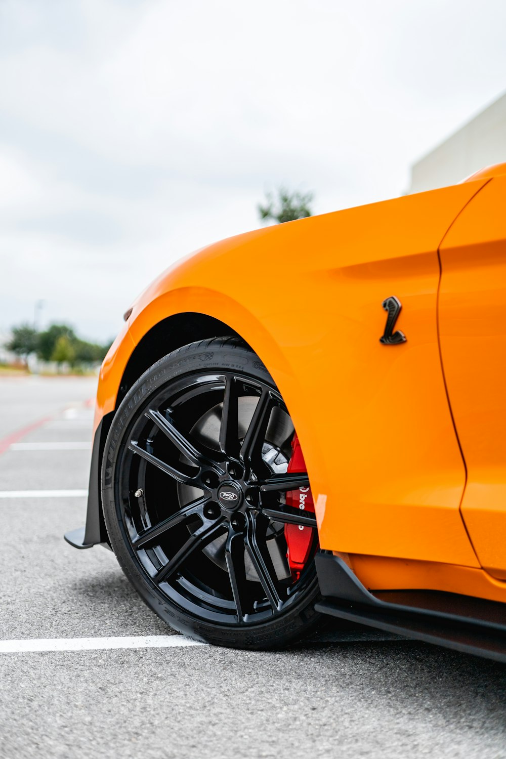 orange and black car on road during daytime