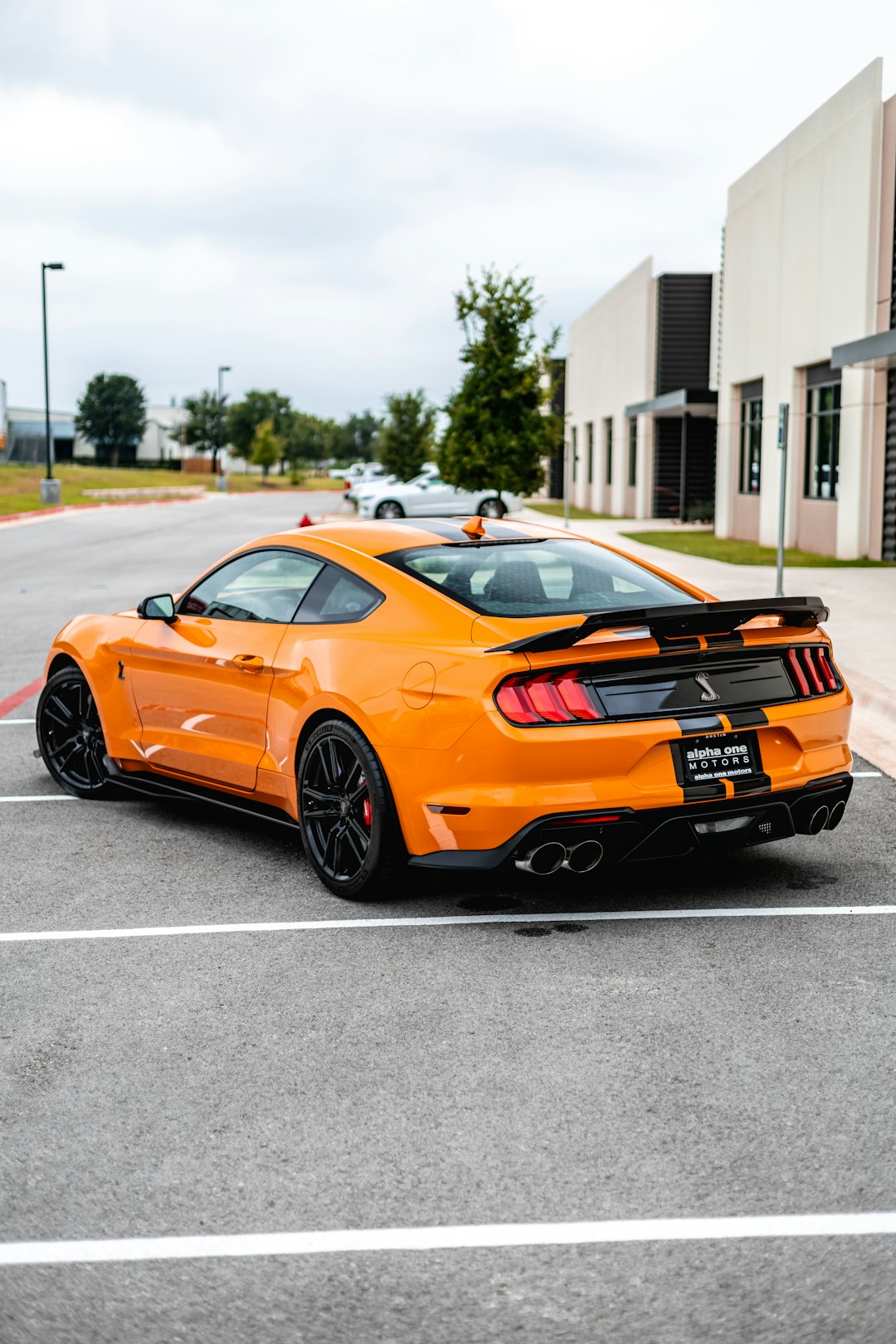 orange and black chevrolet camaro on road during daytime