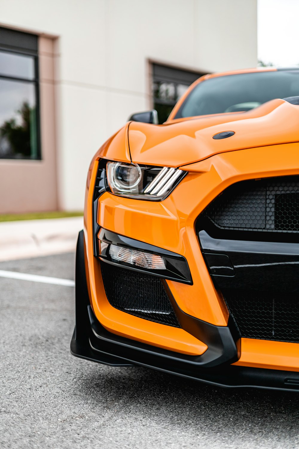 orange and black car on road during daytime