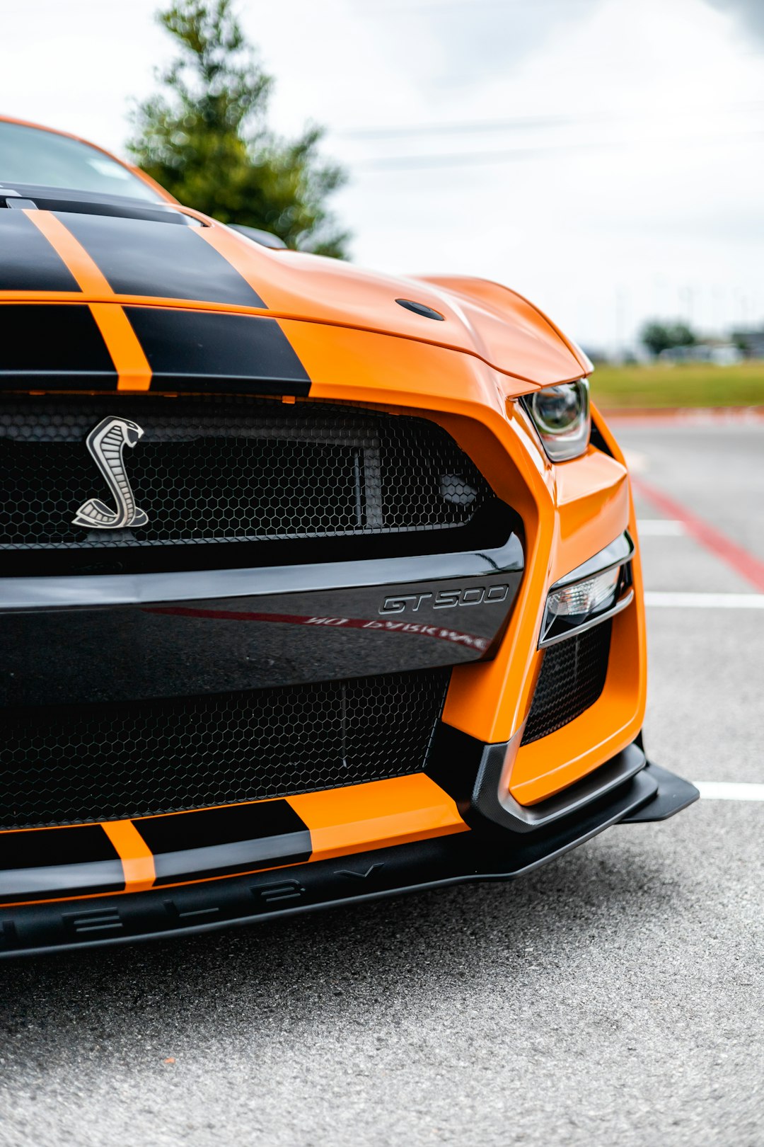 orange and black chevrolet camaro