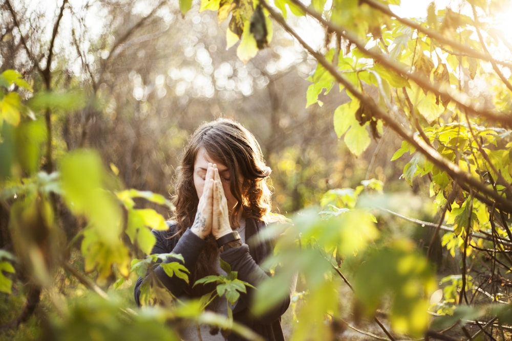 woman in black jacket standing near yellow leaf tree during daytime