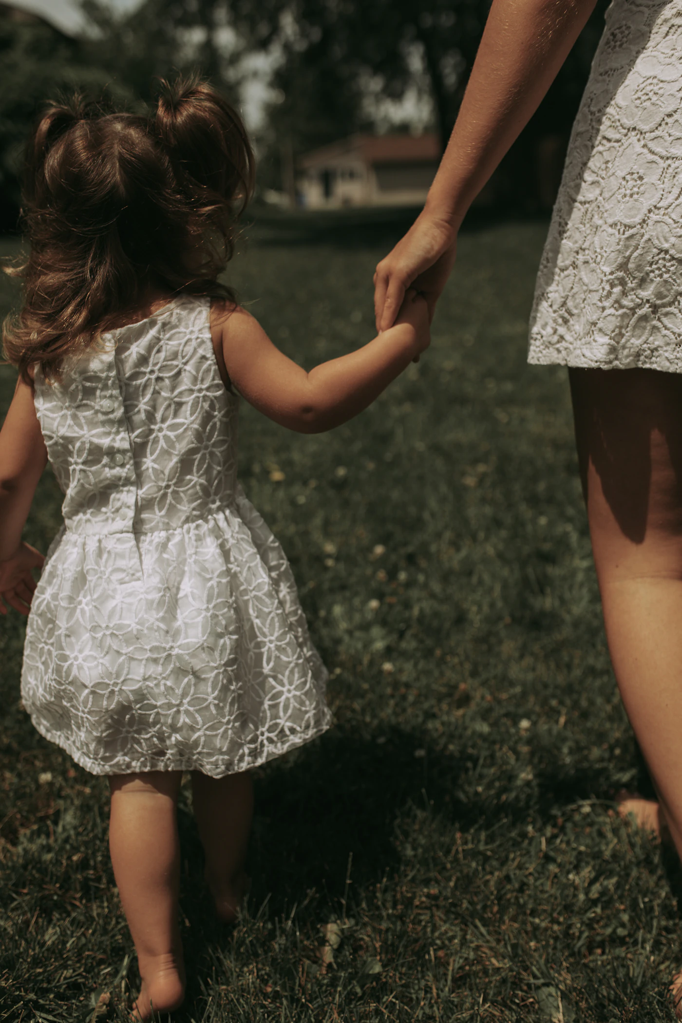 Madre llevando de la mano a su hija