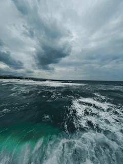 A wide view of the stormy coastline with dark clouds rolling over the sea.