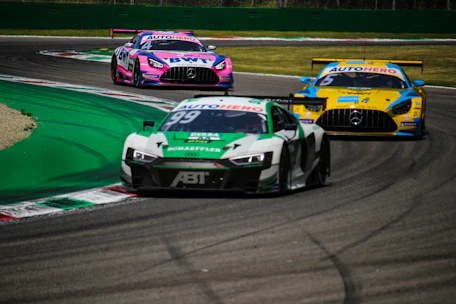 green and white racing car on track