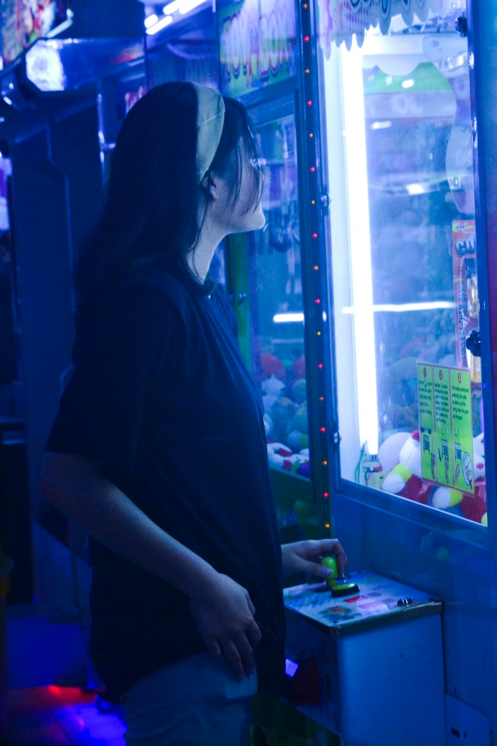 woman in black shirt standing near glass window