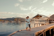 woman in white shirt standing on wooden dock during daytime