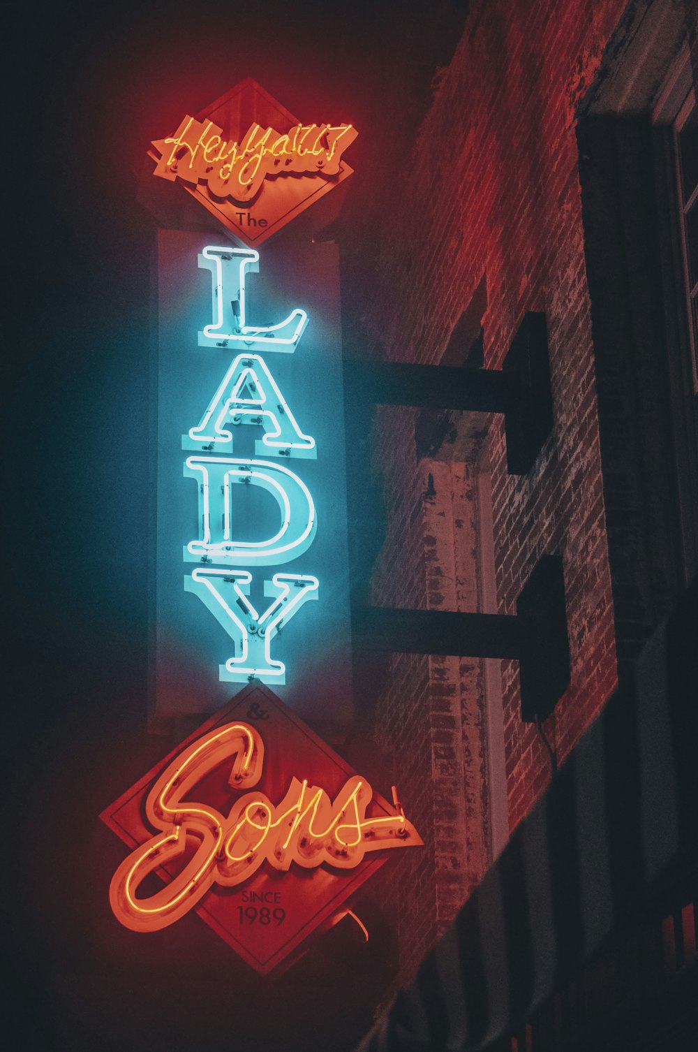 a neon sign that says lady soul on the side of a building