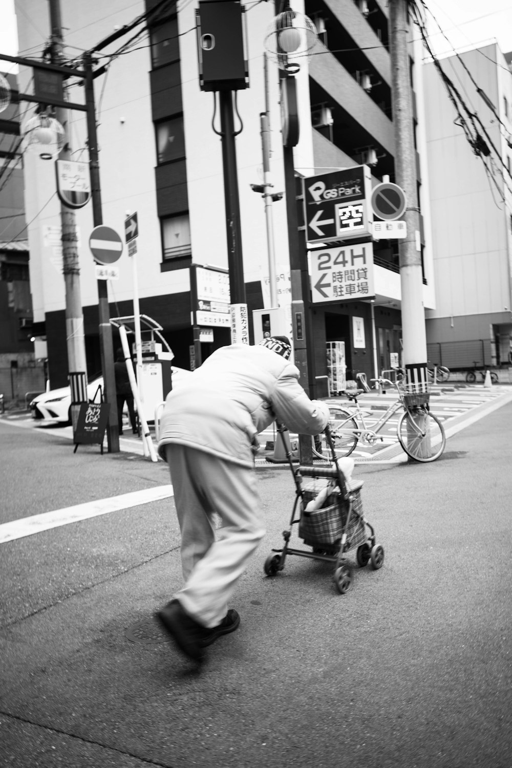 man in white dress shirt and pants riding on black bicycle on road during daytime