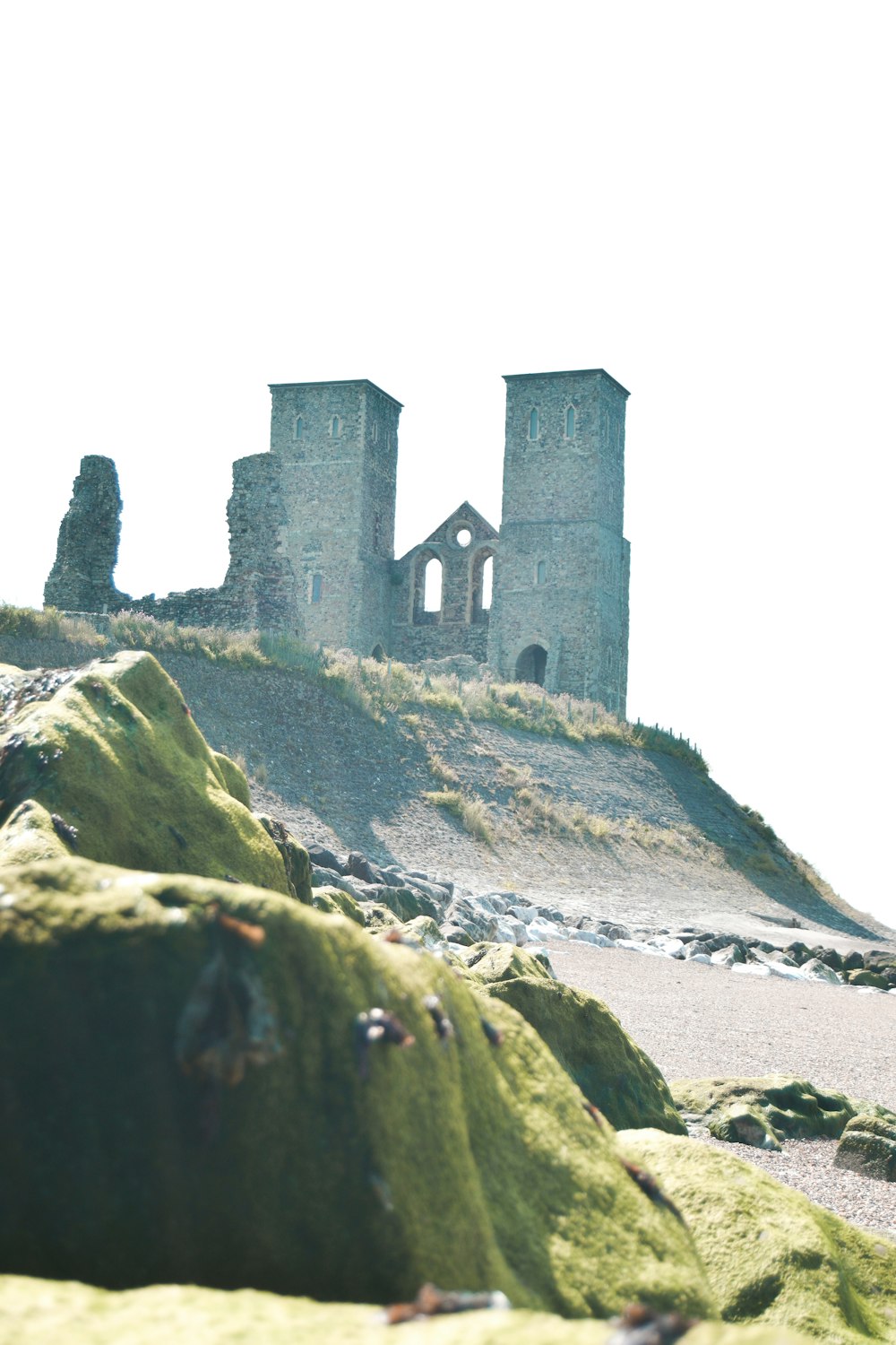 gray concrete castle on green grass covered hill