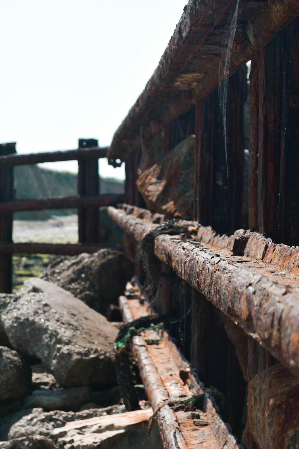 brown wooden fence on brown rock formation during daytime