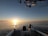 A serene view of the Florida Keys at sunset, with fishing gear on a boat.