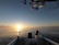 A serene view of the Florida Keys at sunset, with fishing gear on a boat.