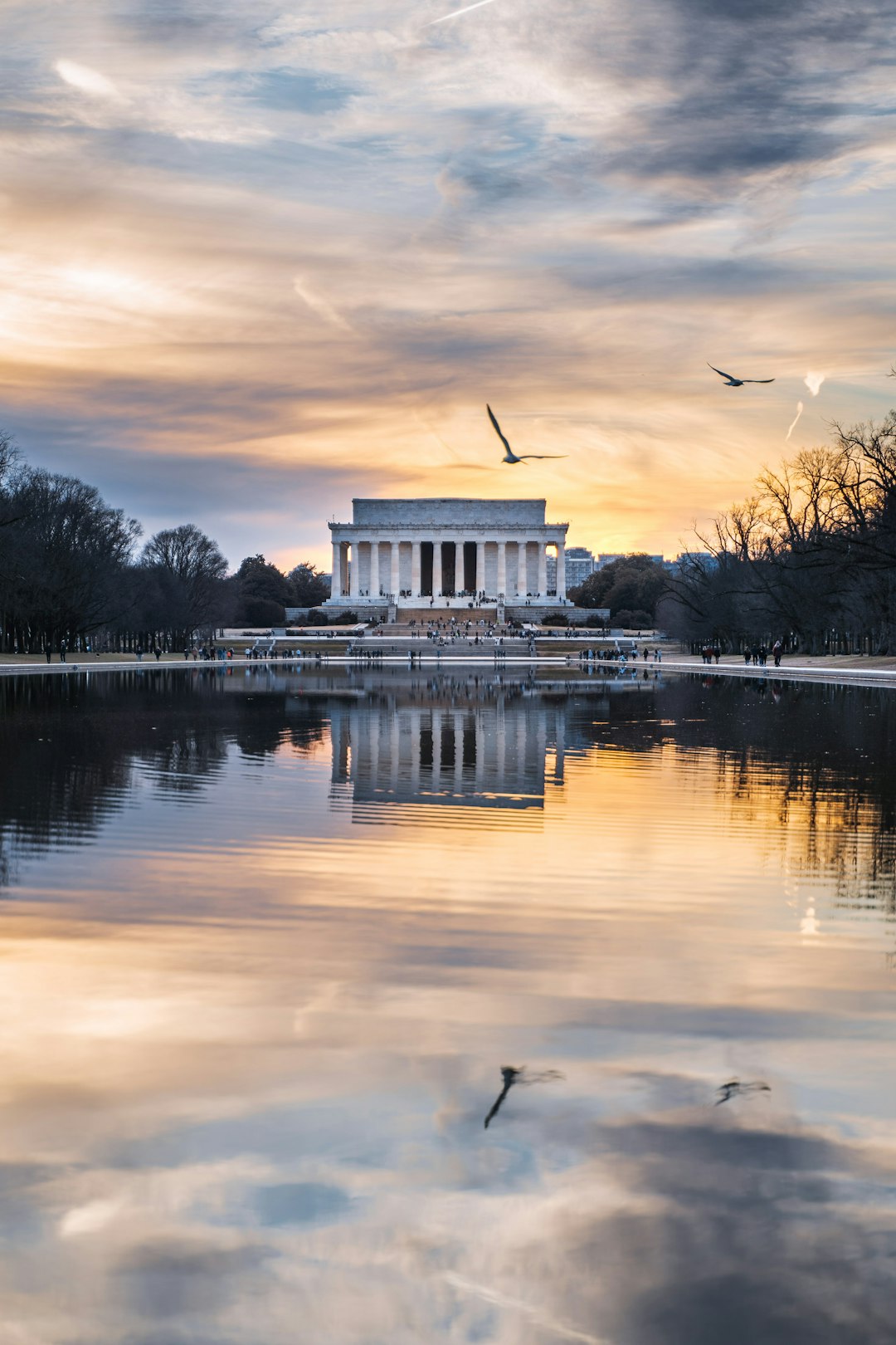 white concrete building near body of water during sunset