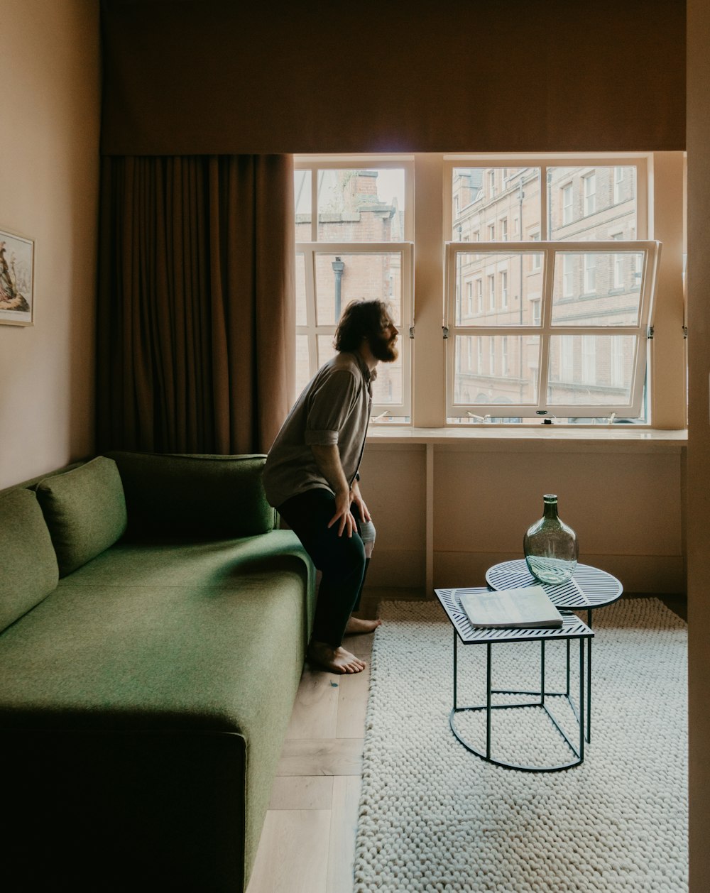 woman in white long sleeve shirt sitting on gray couch