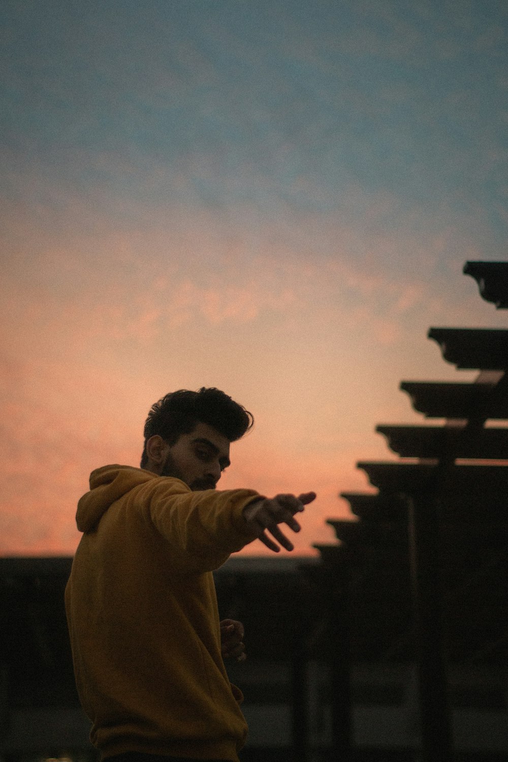 silhouette of man in brown jacket during sunset