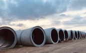 Irrigation pipes laid out ready for installation at a large housing project site.