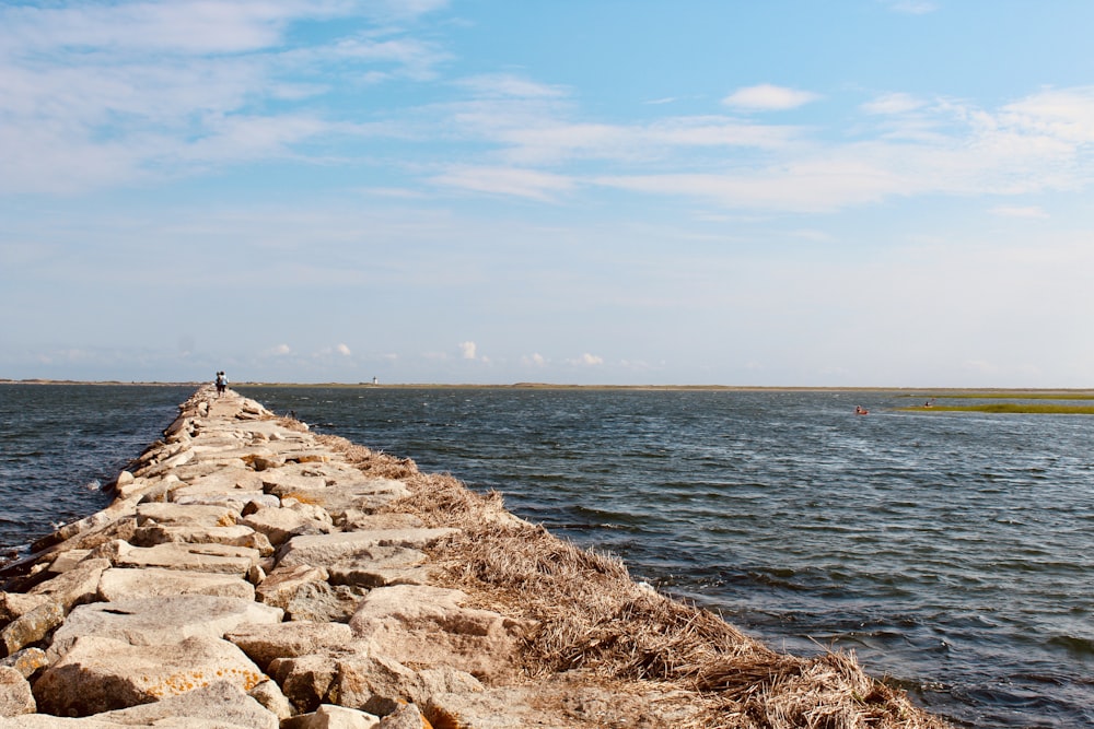 a person standing on the edge of a stone wall