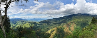 green mountains under white clouds and blue sky during daytime