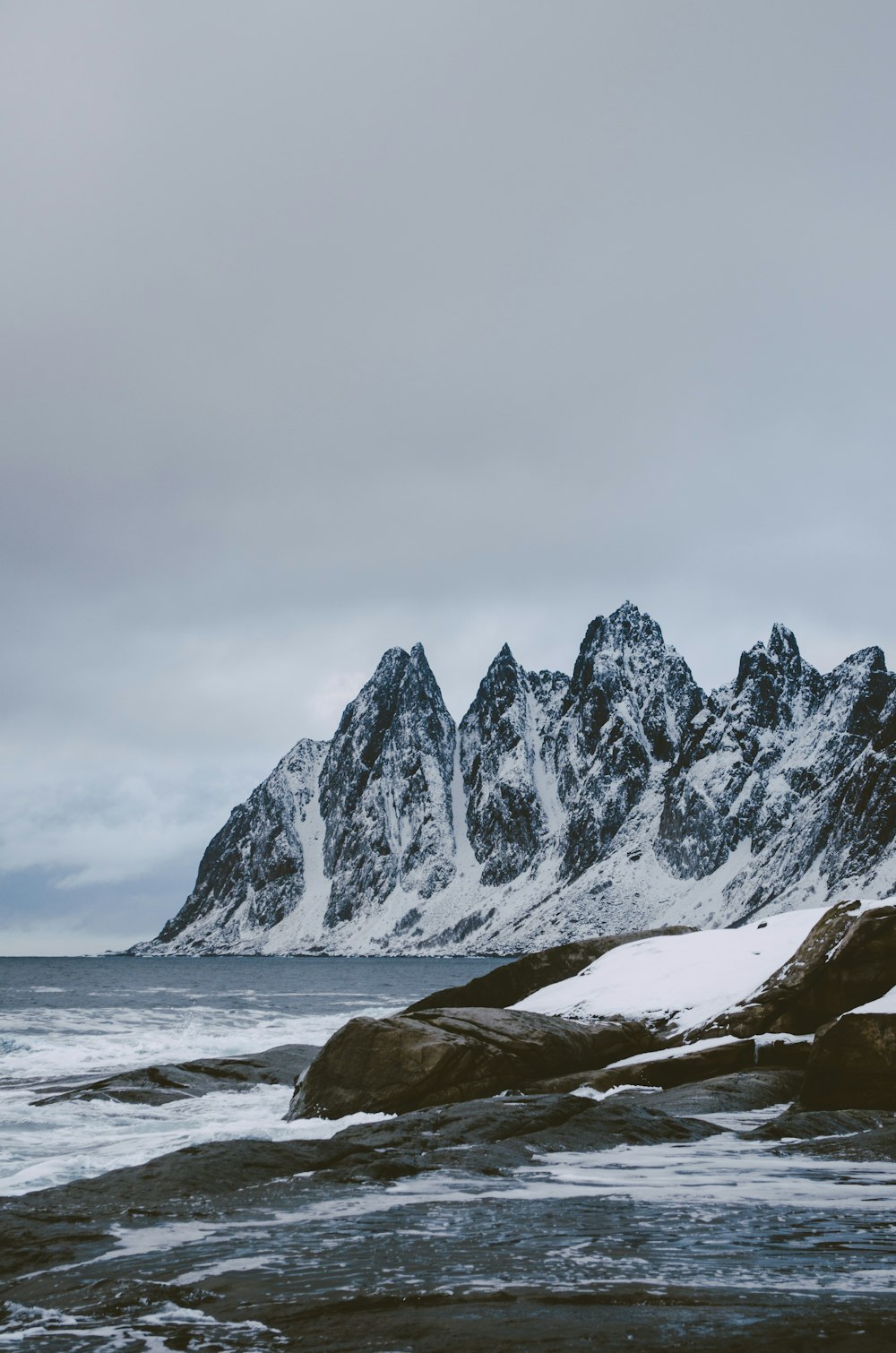 a mountain range with snow on top of it