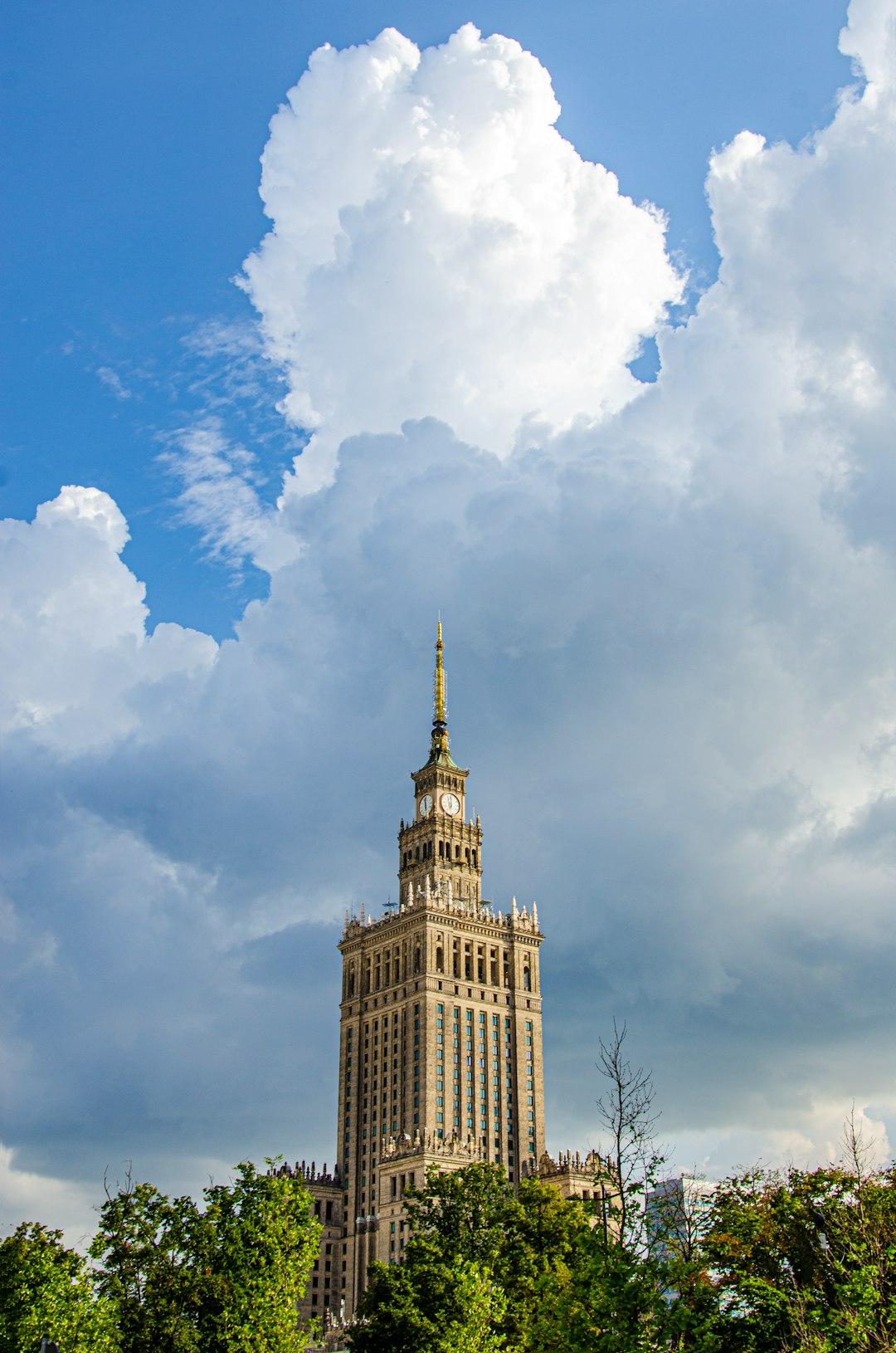 brown concrete building under blue sky and white clouds during daytime