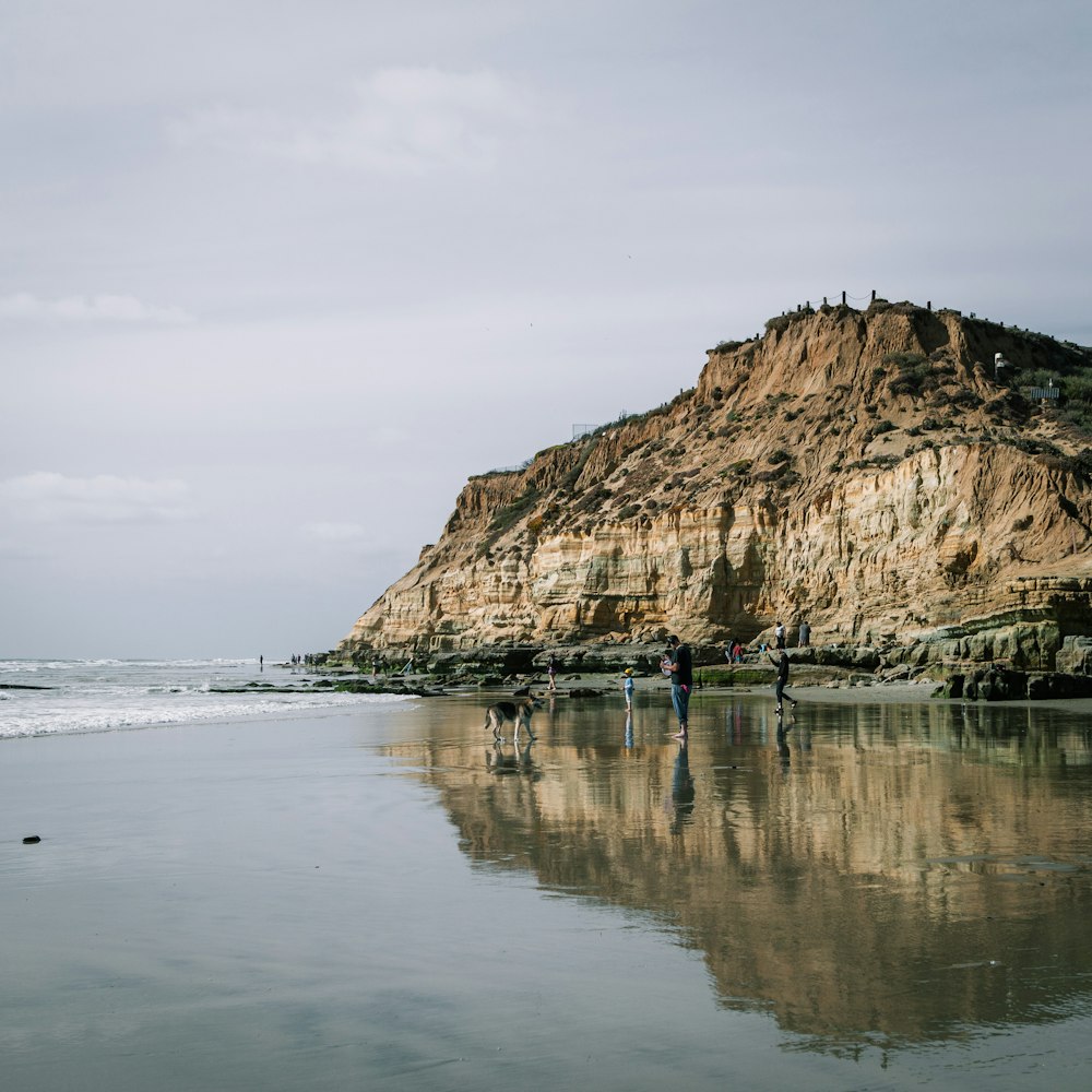 brown rock formation on sea water under white clouds during daytime