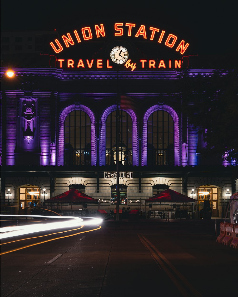 a train station lit up at night time