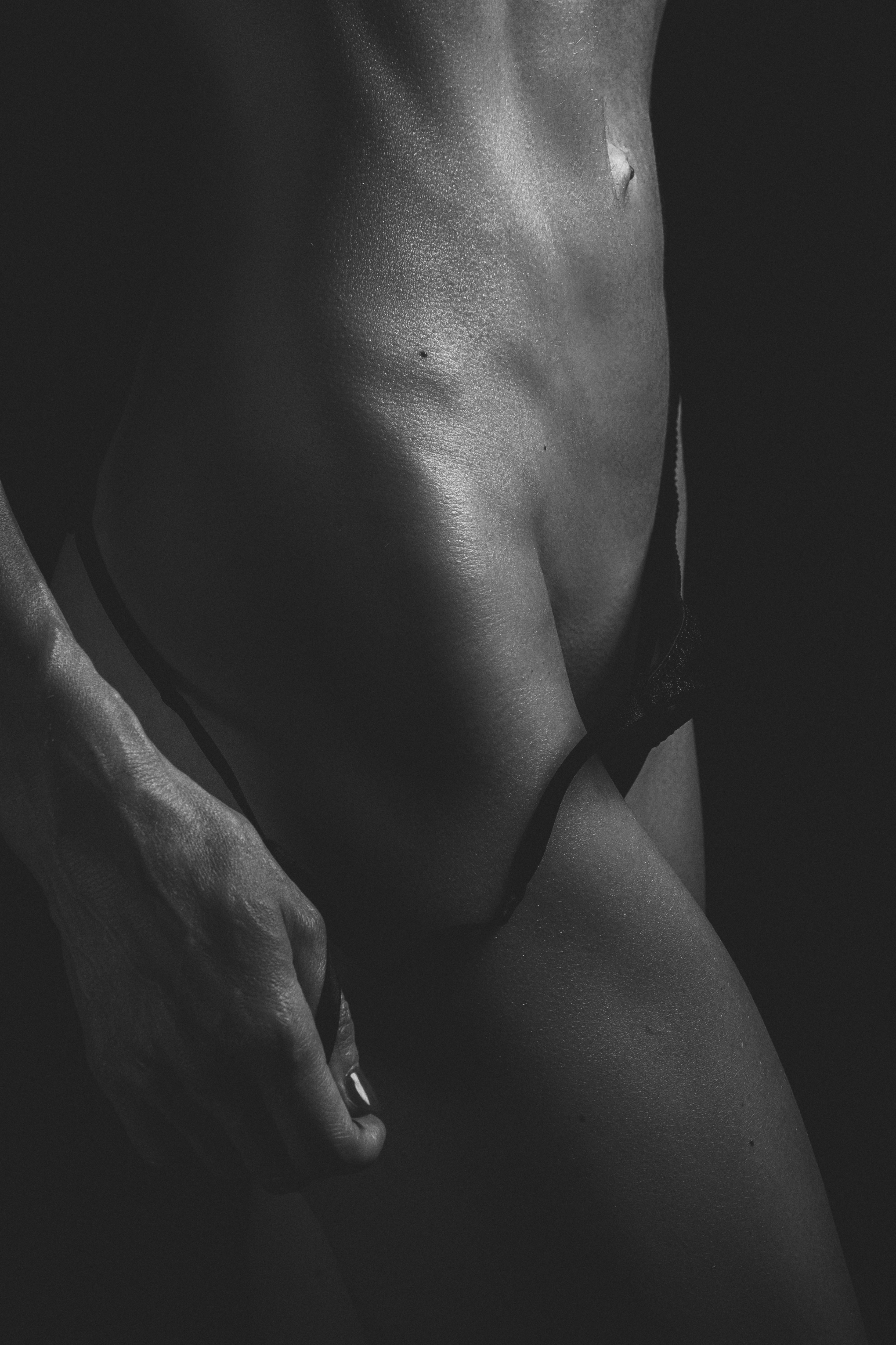 grayscale photo of woman in black brassiere