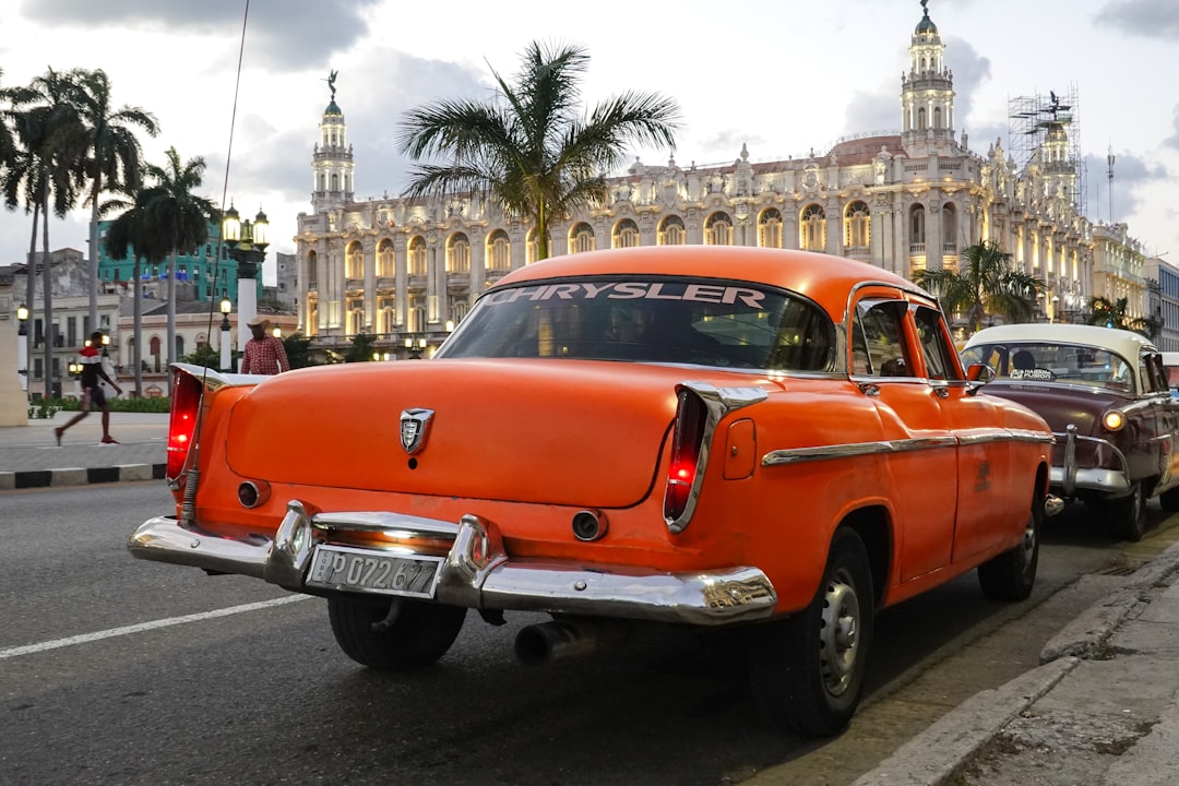 orange and white vintage car on road during daytime