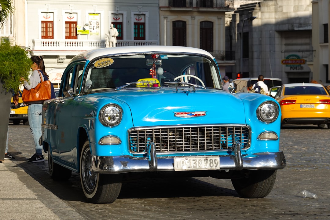 blue and white vintage car on the street