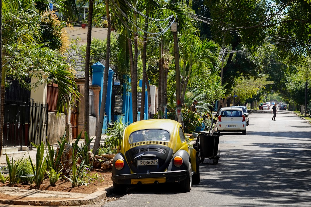 yellow car parked on sidewalk during daytime