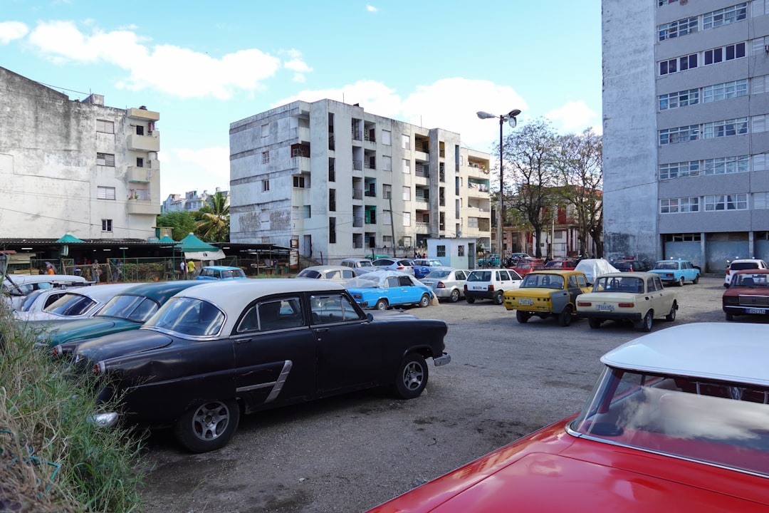 cars parked on parking lot near buildings during daytime