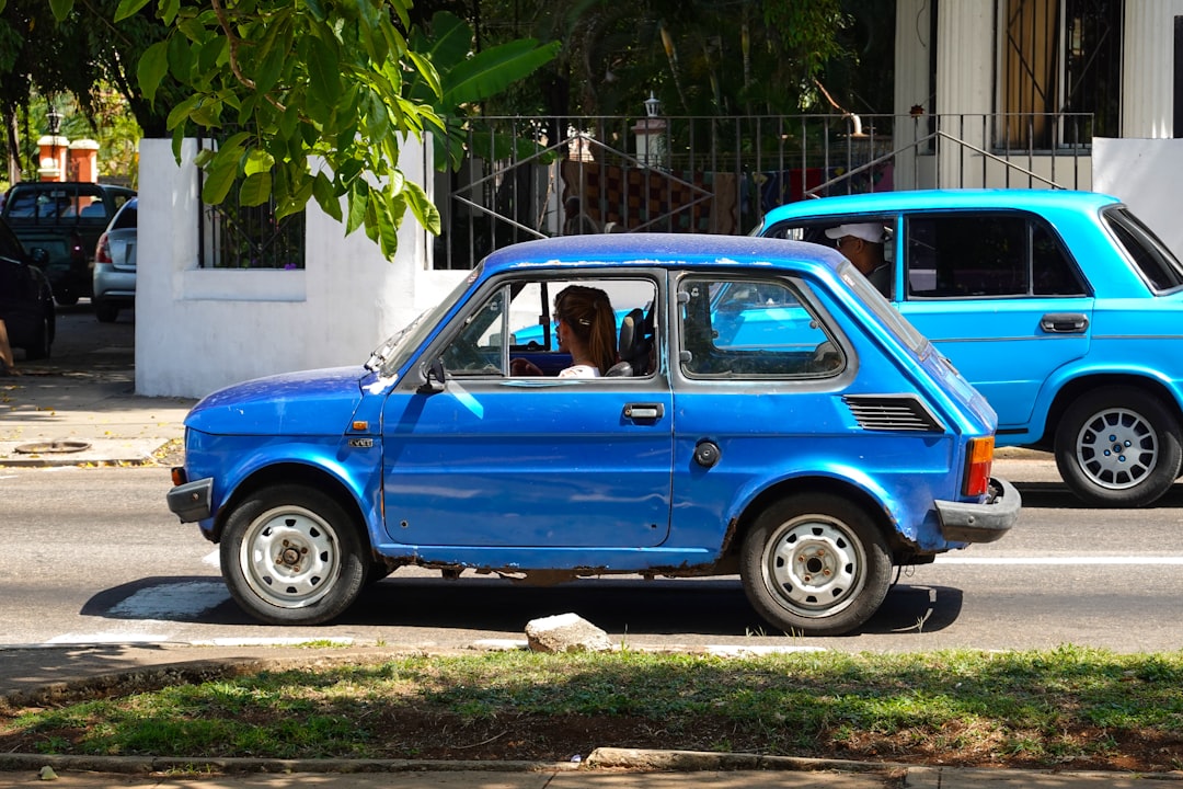 blue car parked on the side of the road