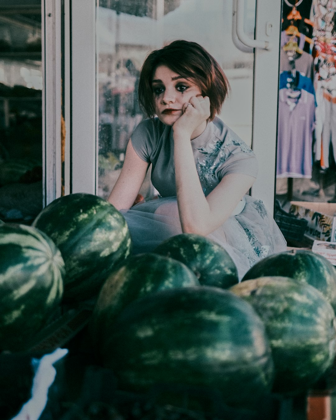 woman in white shirt sitting on green watermelon