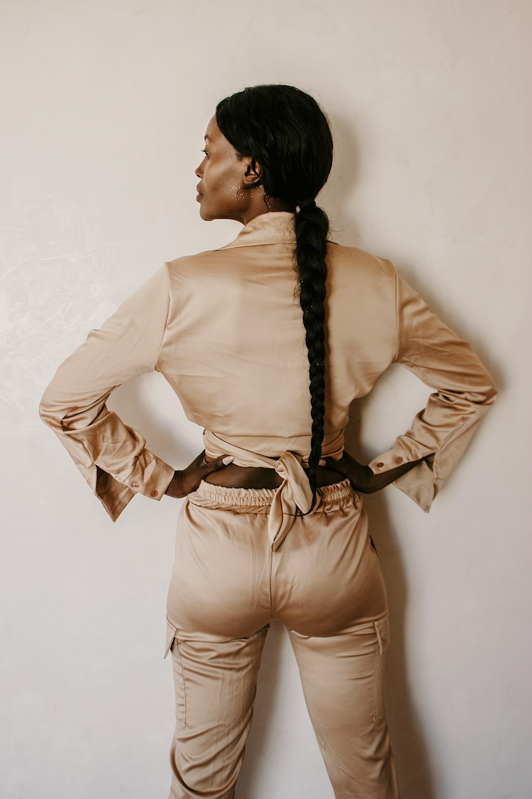 woman in white long sleeve shirt and brown pants