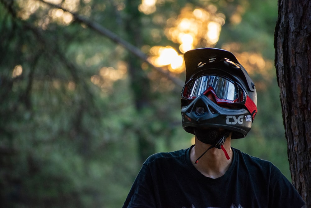 man in black crew neck shirt wearing black and red helmet