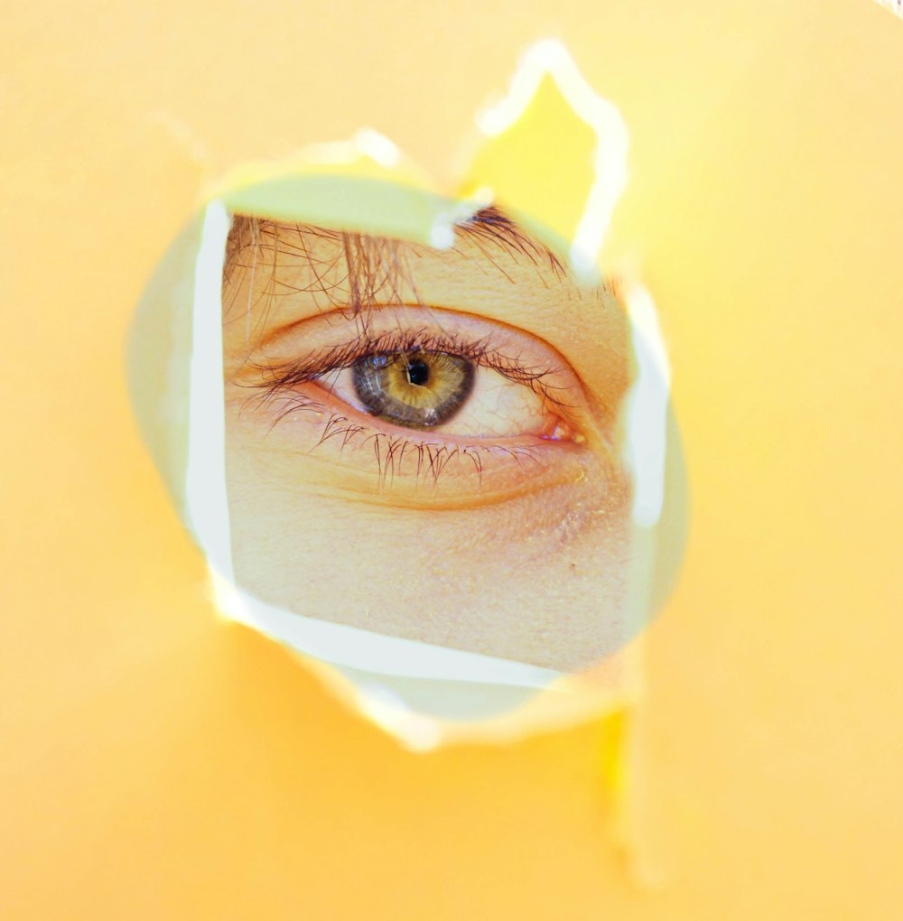 person in yellow hijab with white cream on face