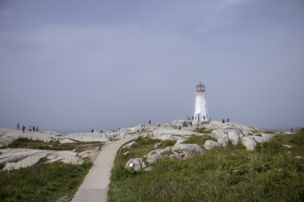 white lighthouse on white snow covered ground during daytime