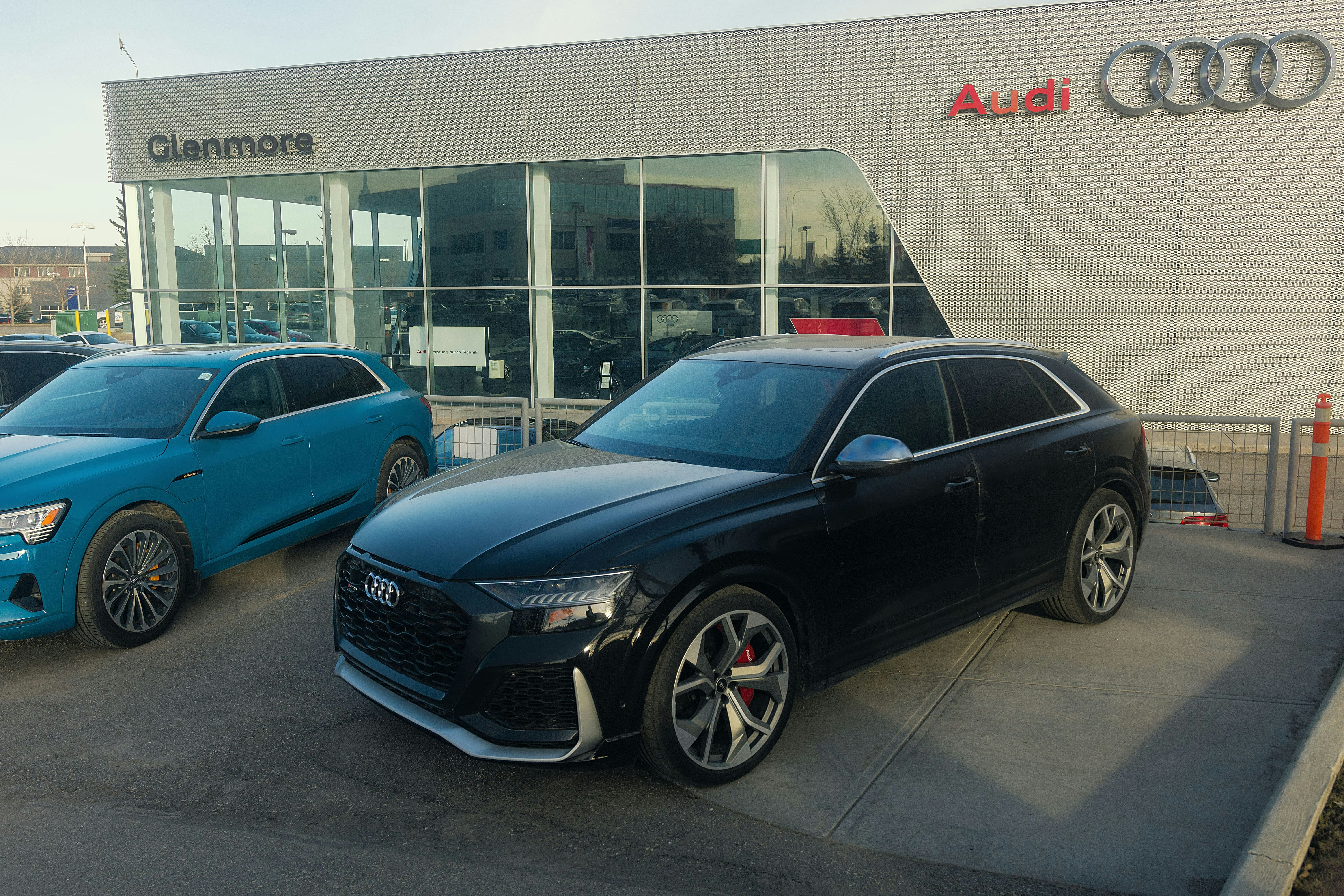 blue bmw m 3 coupe parked near building during daytime