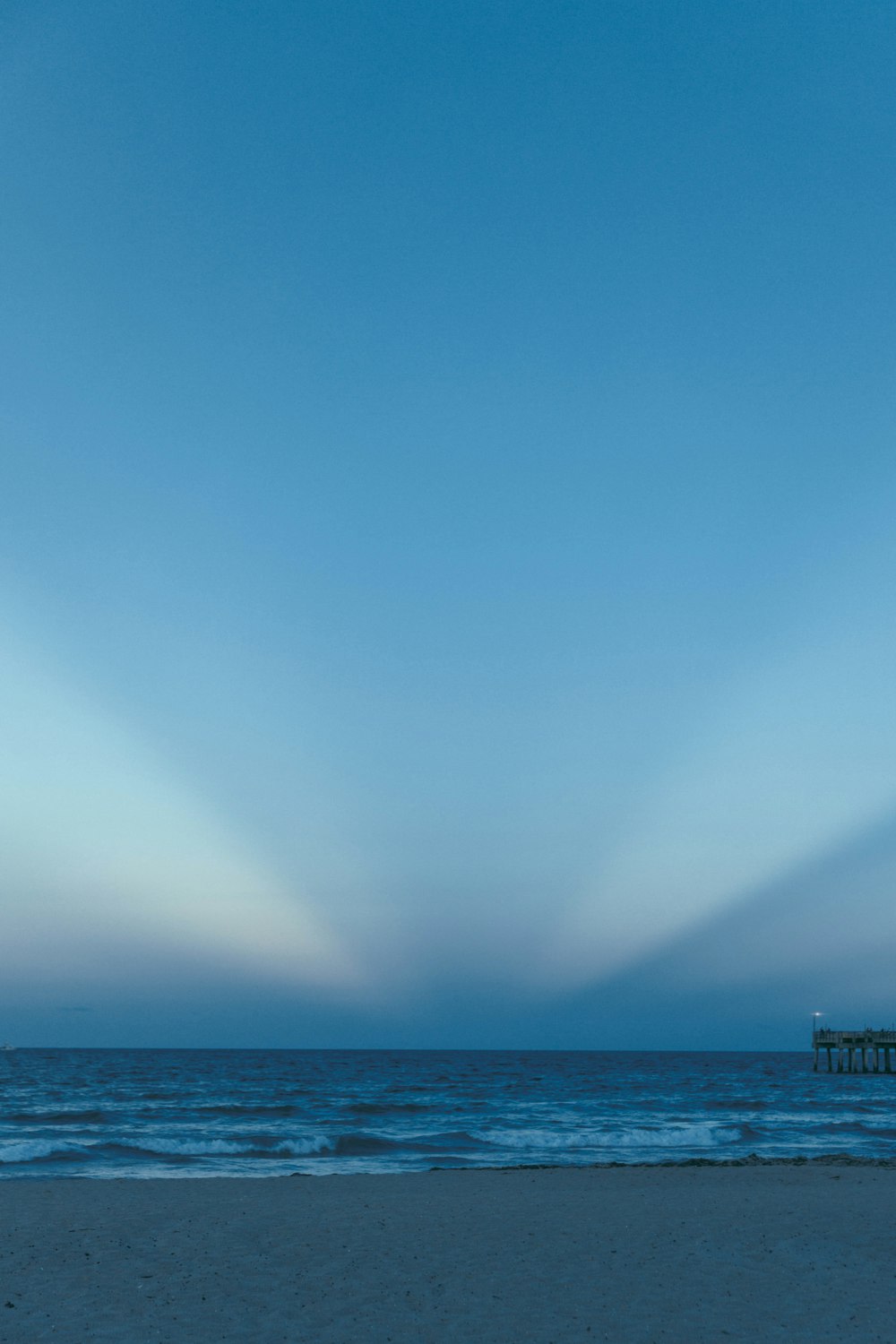 body of water under blue sky during daytime