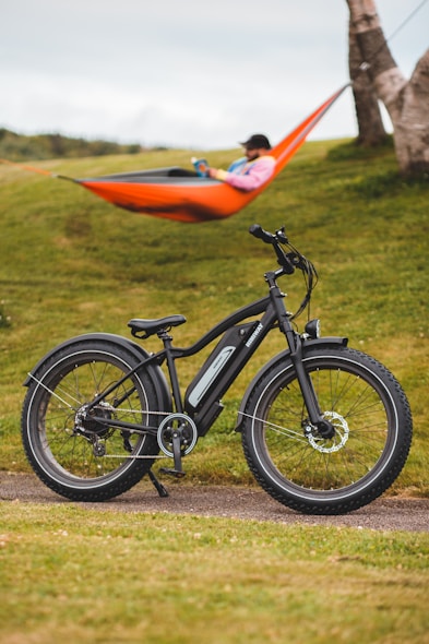 black and orange bicycle on green grass field during daytime