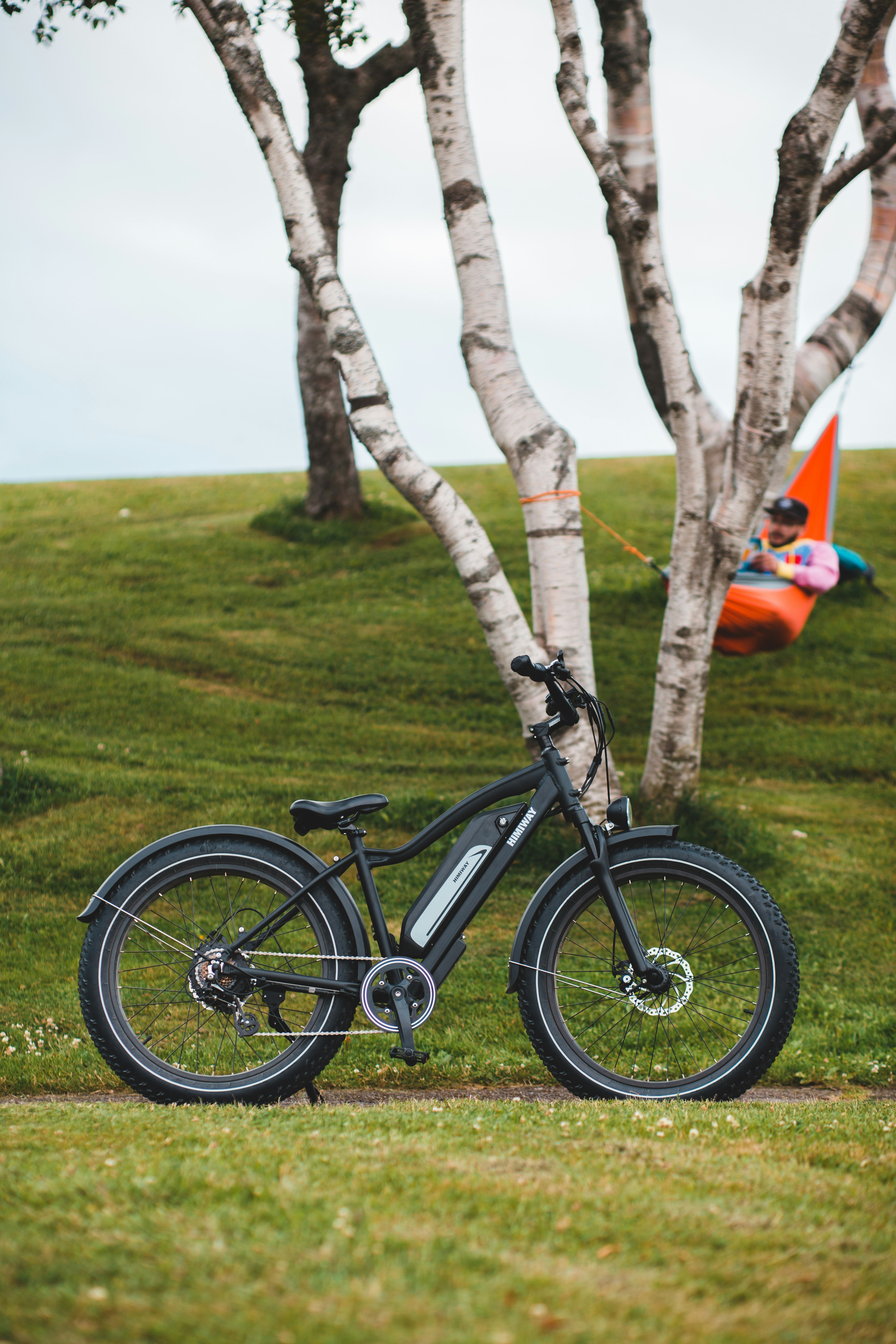 black and gray mountain bike on green grass field during daytime
