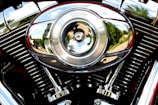 Close-up of a motorcycle's chrome engine gleaming under bright sunlight.