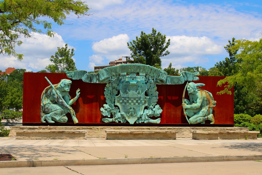 red and green concrete statue under blue sky during daytime