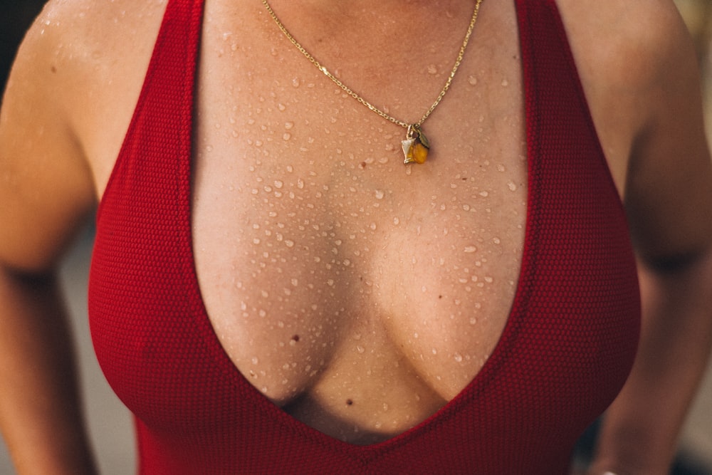 woman in red tank top wearing silver necklace