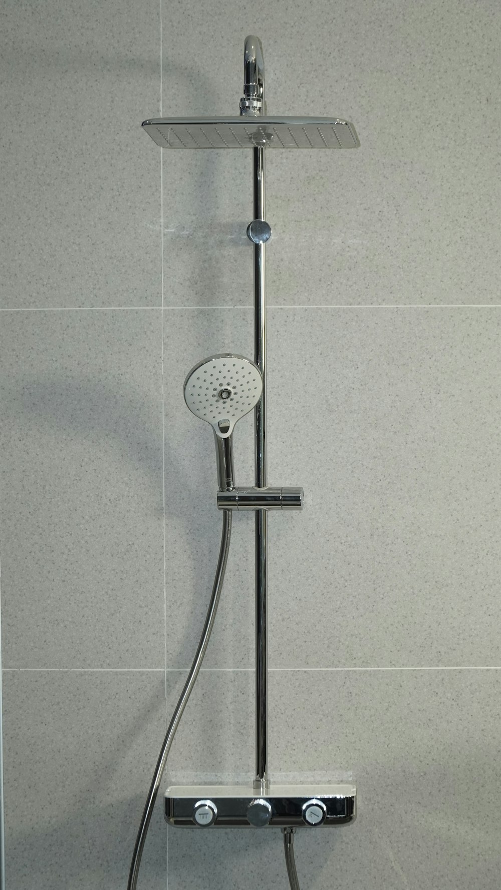 silver shower head mounted on white wall