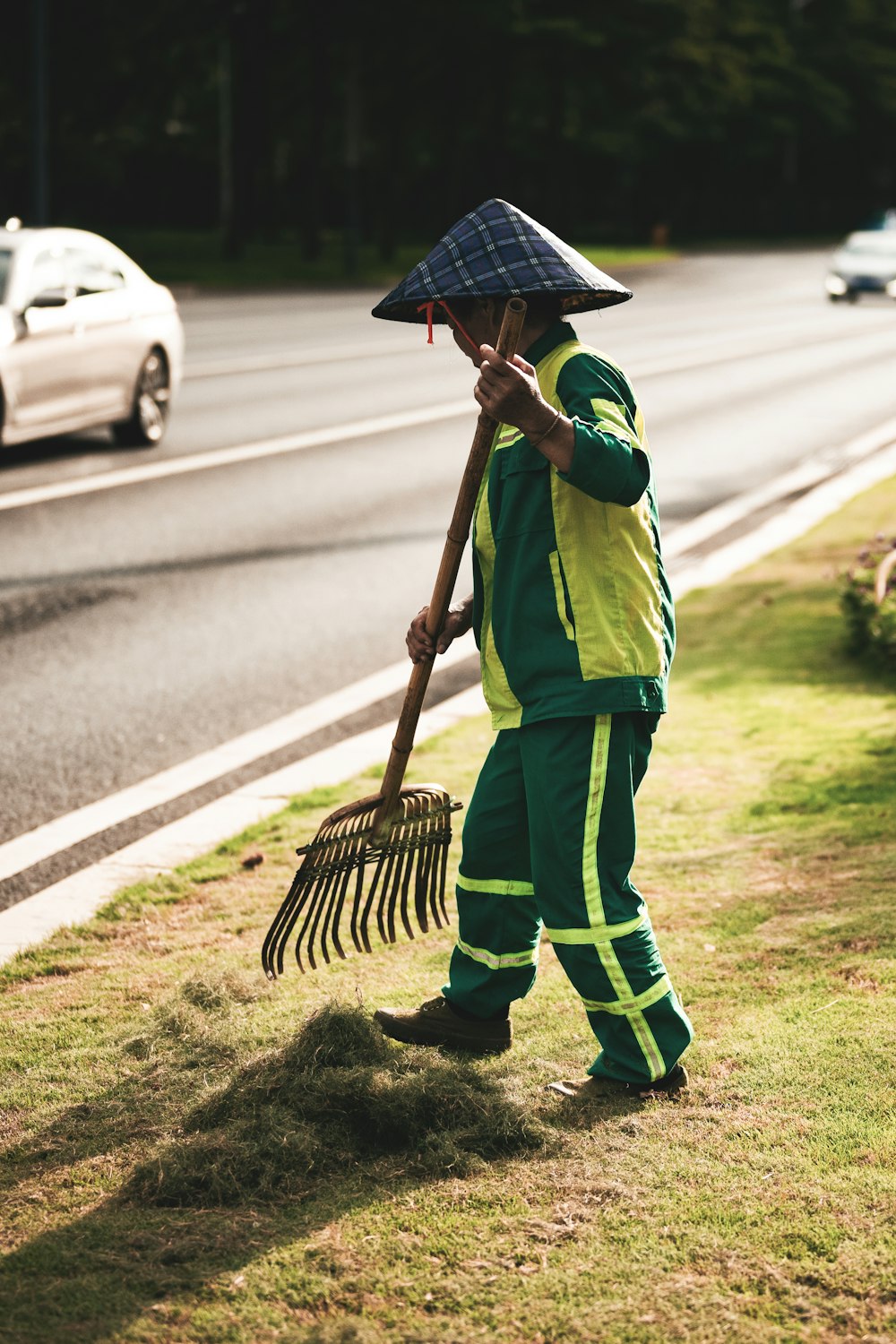 boy in green and yellow shirt holding umbrella walking on street during daytime