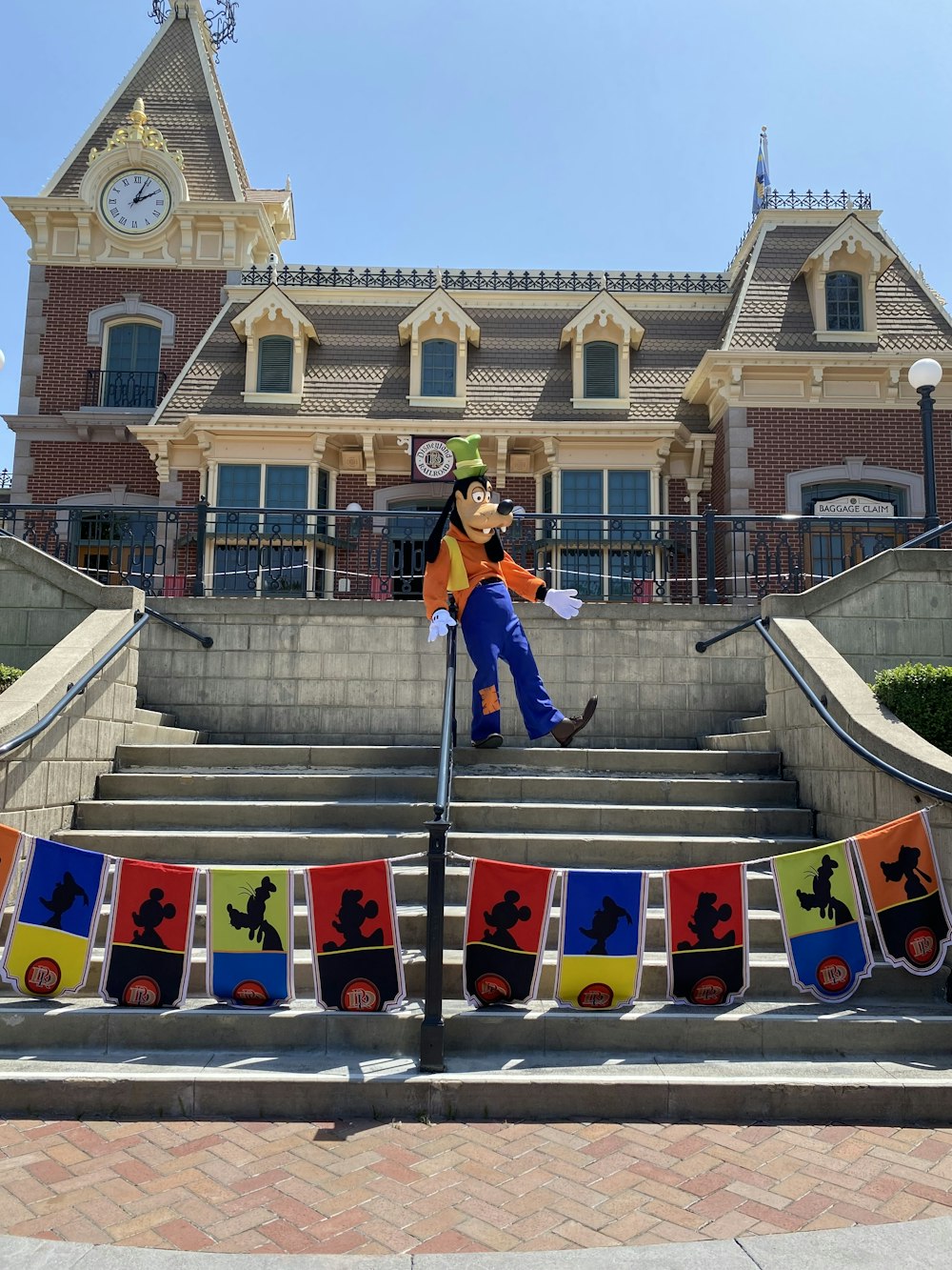 man in blue jacket and blue denim jeans walking on stairs during daytime