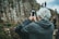 man in black hoodie holding smartphone
